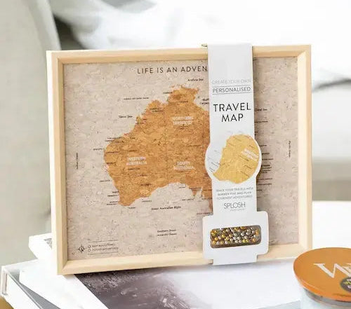 Australia Pin Board Travel Map table decoration GiftDealAU product image. Framed travel map of Australia with a product packaging on top, placed on books.