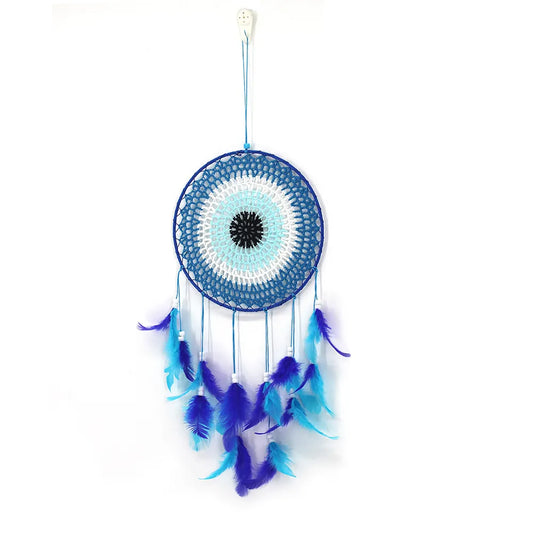 Evil Eye Dream Catcher A blue and white crocheted dreamcatcher with a black center, hanging from a white string on a plain white background.
