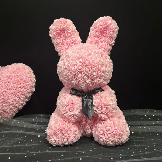 Foam Rose Bunny A pink bunny-shaped figure crafted from decorative foam roses, adorned with a black ribbon bow.
