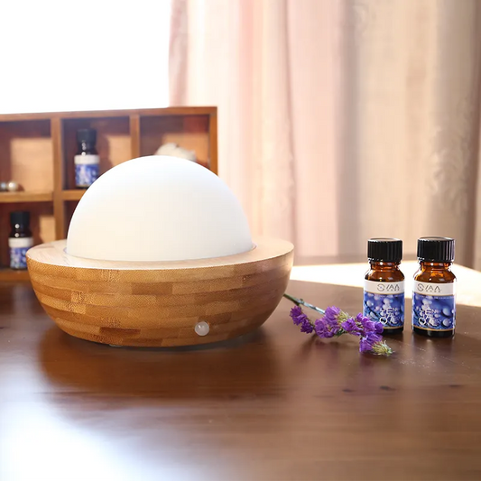 Aroma Natural Bamboo Diffuser Wooden diffuser with essential oil bottles on a wooden surface
