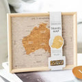 Australia Pin Board Travel Map table decoration GiftDealAU product image. Framed travel map of Australia with a product packaging on top, placed on books.