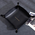 Suede Valet Tray Leather Catchall Tray Black leather tray with gold accents on a dark surface