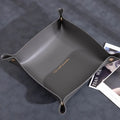 Suede Valet Tray Leather Catchall Tray Gray leather tray with gold text on a dark surface