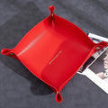 Suede Valet Tray Leather Catchall Tray Red leather tray with gold accents on a dark surface