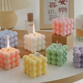 Bubble Cube Candle
GiftDealAU product image. Colorful bubble-style candles on a table with a perfume bottle and mug in the background.