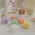 Bubble Cube Candle colorful
GiftDealAU product image.Colorful bubble-shaped candles on a table with a mug and decorative items.
