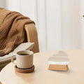 Cup of coffee on a saucer with a small Cloud Weather Station on a surface, possibly a table or couch. giftdealau product image