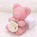 Crystal Diamond Bear Pink teddy bear with a white rose on a white background