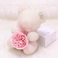 Crystal Diamond Bear White teddy bear with a pink rose on a white background