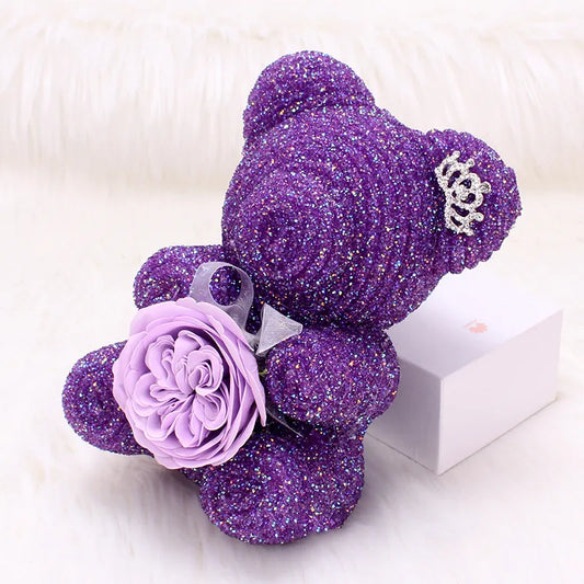 Crystal Diamond Bear Purple glittery teddy bear with a flower on a white background