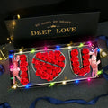 Deep Love I Love You Rose Gift Box Decorative sign with 'I LOVE YOU' made of red roses, surrounded by fairy lights, on a dark background.