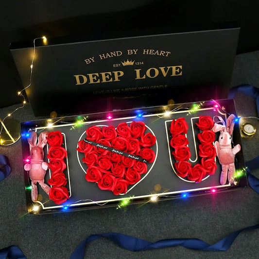 Deep Love I Love You Rose Gift Box Decorative sign with 'I LOVE YOU' made of red roses, surrounded by fairy lights, on a dark background.