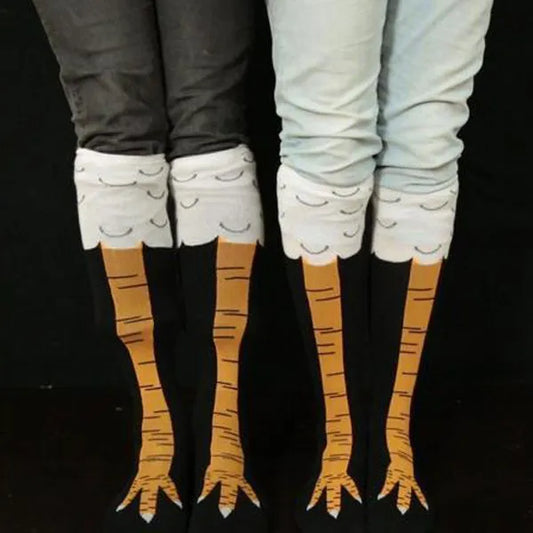 Funny Chicken Legs Socks Two pairs of legs wearing socks with cartoonish bird legs and feet on a black background.