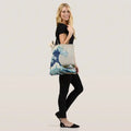 Great Wave Shopping Bag women holding GiftDealAU product image. Woman holding a tote bag with a wave design on a white background