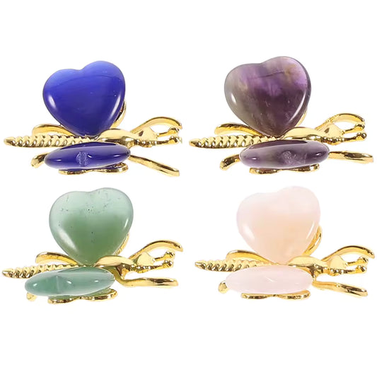 Heart Shaped Crystal Butterfly Ornament Four heart-shaped hair claw clips arranged in a 2x2 grid on a white background. Each clip features a gold-tone metal butterfly design with a different colored heart stone: blue, purple, light green, and pale pink, with a matching oval stone underneath.