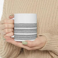 Hidden Message Ceramic Coffee Mug GiftDealAU Ptoduct image. White mug with black pattern held by a person wearing a beige sweater.