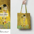 Klimt The Kiss Tote Bag GiftDealAU product image. Tote bag with 'The Kiss' by Gustav Klimt design held by a hand on a white background.