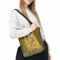 Klimt The Kiss Tote Bag women hanging bag GiftDealAU product image. Person holding a bag with 'The Kiss' by Gustav Klimt design.