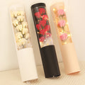 LED Flower Bouquet Gift Box Three cylindrical floral arrangements with LED lights on a textured surface.