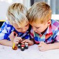 Memory Maze Challenge Game two kid playing GiftDealAU product image. Two young boys playing with a fidget spinner on a light surface.
