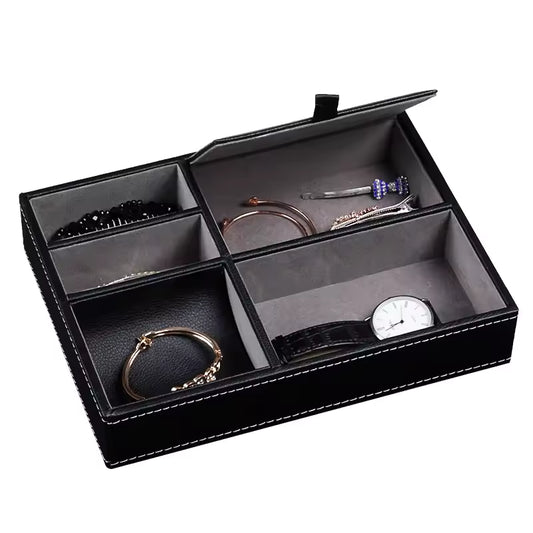 Mens Nightstand Organiser Tray
Black jewelry box with compartments containing jewelry items on a white background