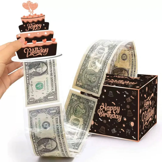 Money Pull Out Gift Box A hand holds a 3-tier birthday cake topper with 'Happy Birthday' text, while a roll of U.S.