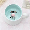 Peekaboo Animal Mug – Cute 3D Hidden Surprise Ceramic Coffee Cup
cow variant GiftDealAU product image. Cute cow figurine in a light blue mug on a pink surface