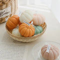 Pumpkin Shaped Soy Candles Decorative pumpkins in various colors with 'Vissy' tags in a basket on a light surface.