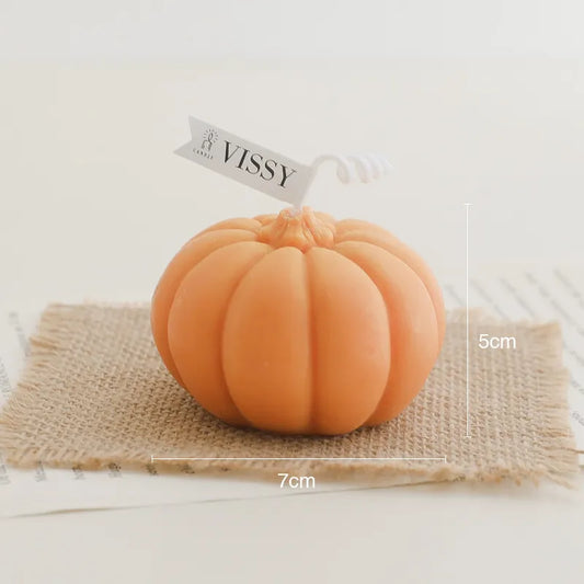 Pumpkin Shaped Soy Candles Small orange pumpkin with a 'Vissy' tag on a textured surface
