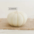 Pumpkin Shaped Soy Candles White sphere with 'VISSY' branding on a textured surface