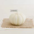 Pumpkin Shaped Soy Candles White spherical soap on a textured mat with measurement details, branded 'VISSY'.