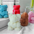 Rose Teddy Bear Soy Candles in multiple colors including blue, red, pink, brown, and white, arranged on a table for home decor. Colorful teddy bear-shaped candles on a white surface with text about color styles and fragrances.