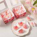 Strawberry Shaped Scented Candles box giftdealau product image. Pink strawberry-shaped candles in decorative boxes on a white surface with tulips.