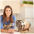 Wooden Whiskey Barrel GiftDealAU women holding wine glass product image. Woman holding a glass of red wine next to a wooden wine barrel in a kitchen.